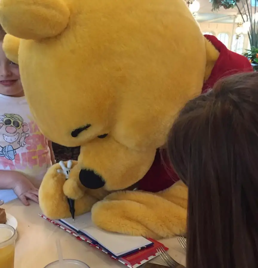 Winnie the Pooh signing our Disney World Autograph Book