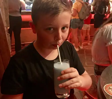 My Son trying Star Wars Blue Milk as part of a Blue Banta at Oga's Cantina in Hollywood Studios.