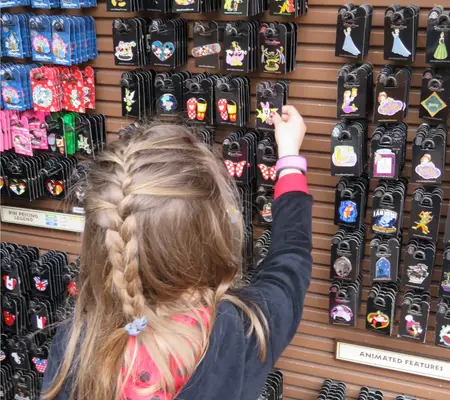 My daughter looking at Pins at Disney World