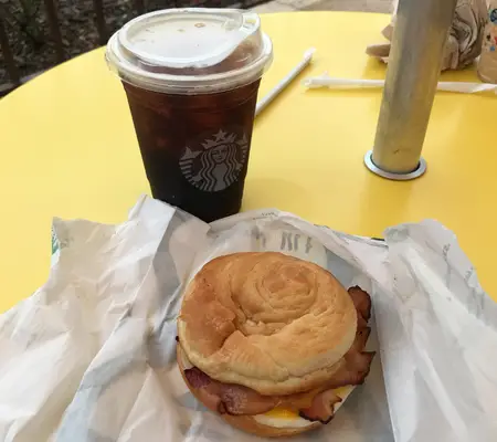 A Starbucks breakfast sandwich and iced coffee from the Main Street Bakery