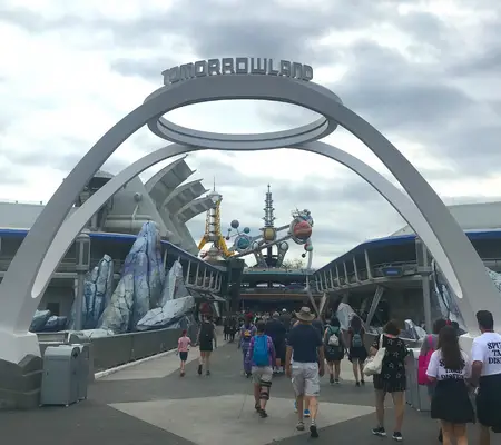 wait at the entrance of Tomorrowland for rope drop